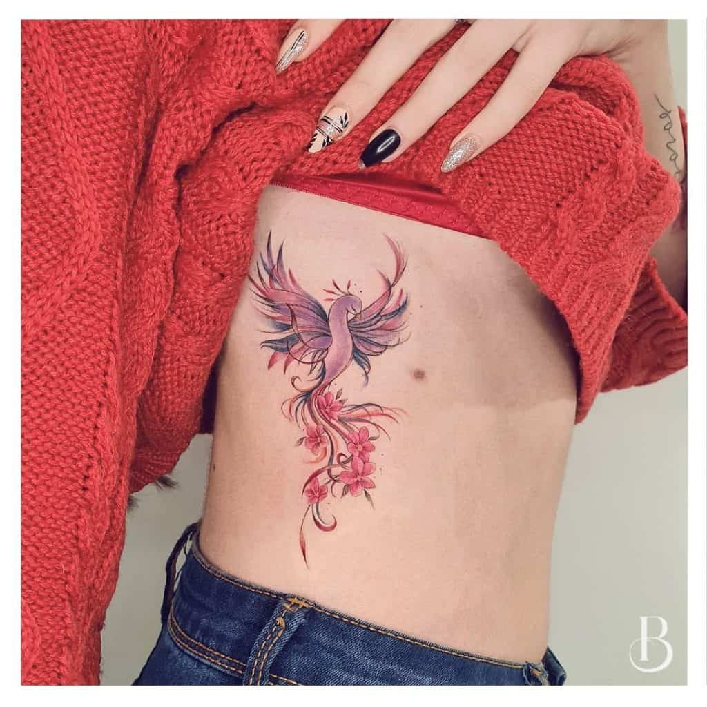 phoenix tattoo on side of women
