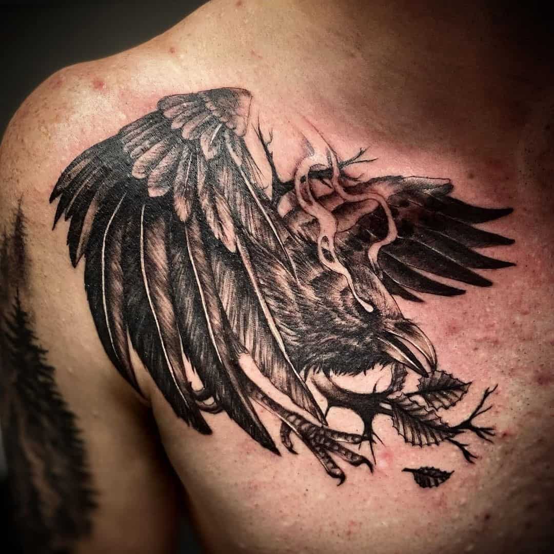 Black And Realistic Raven Tattoo Across Chest 