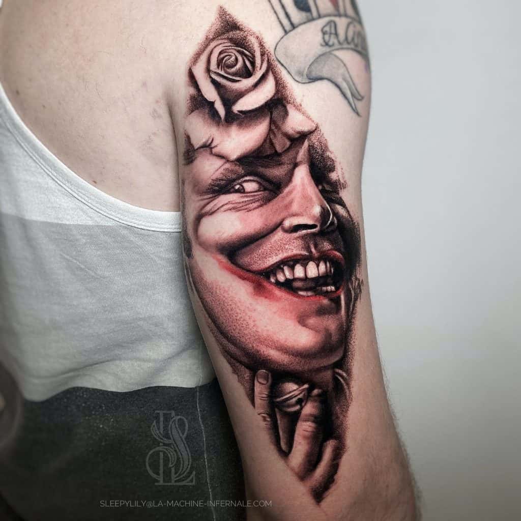Joker Face Tattoo Over Arm Red Ink 