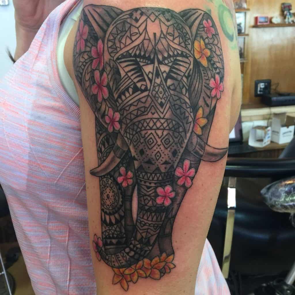 An elephant Tattoo with flowers on The Arm