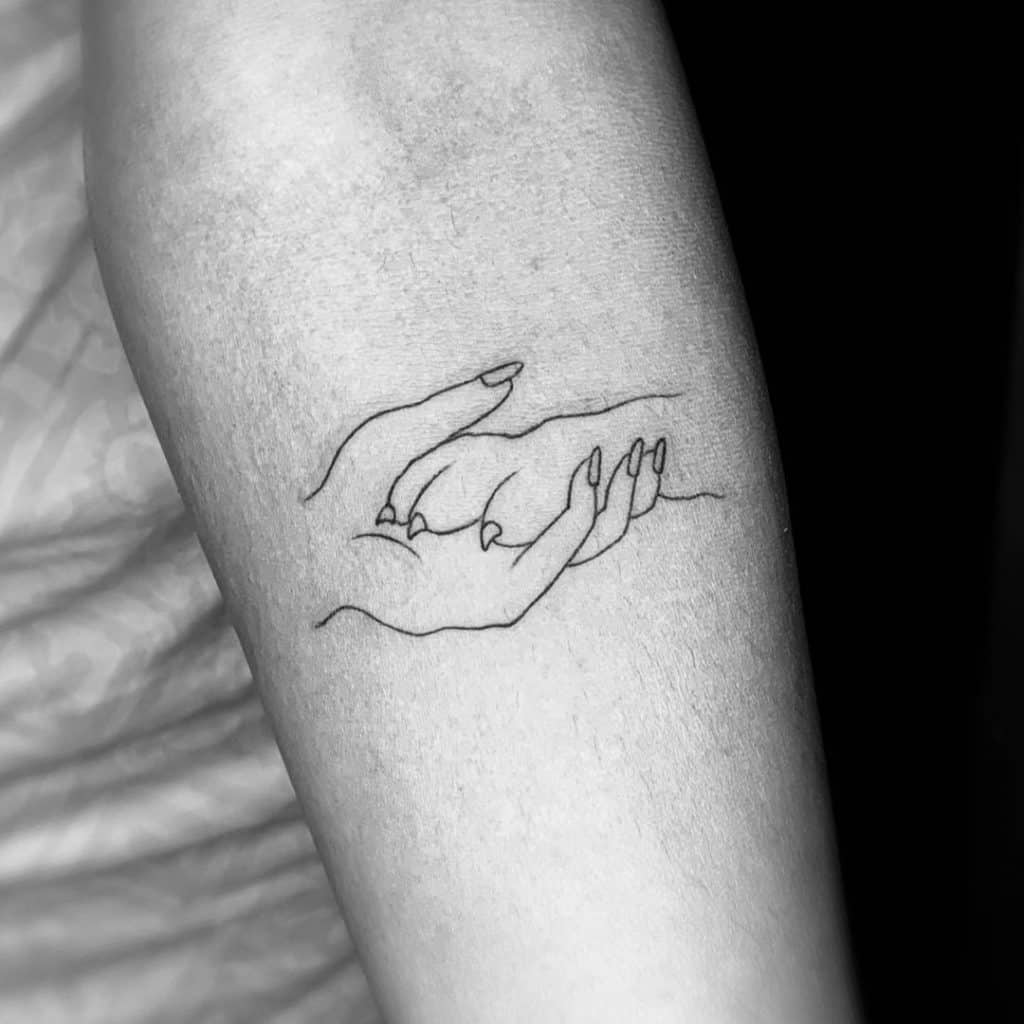 Human Hand And Dog Paw Tattoo