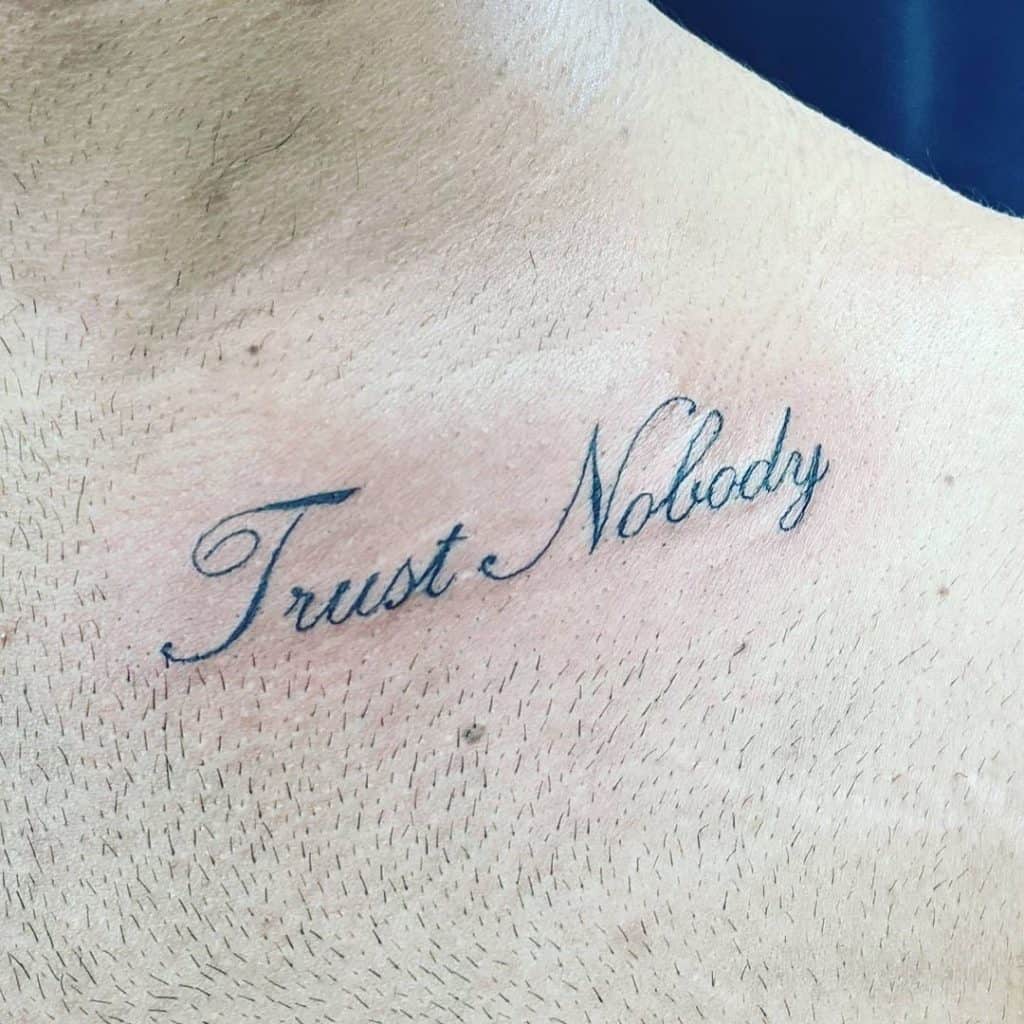Trust Nobody Small Tattoo Over Chest