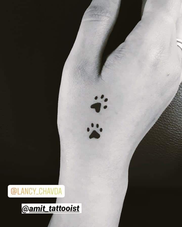 Two Black Dog Paws Tattoo On Hand