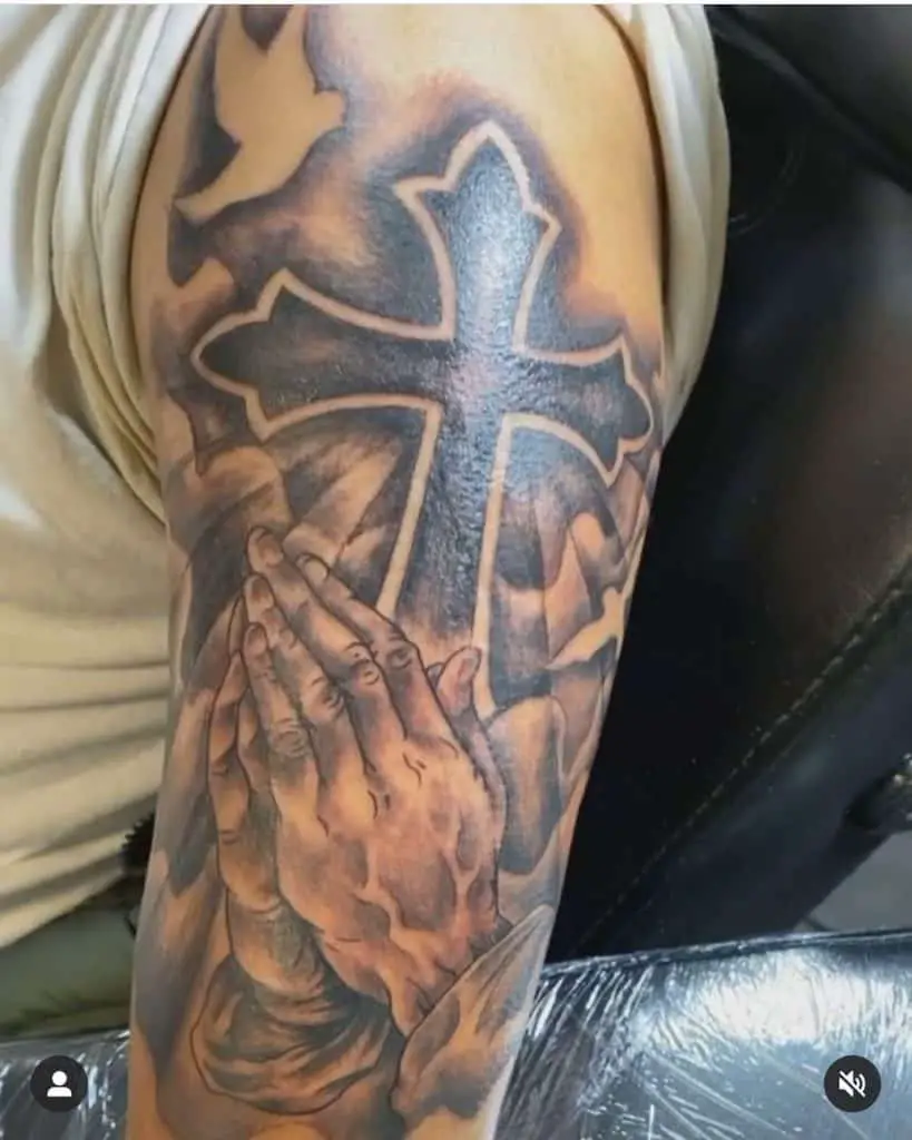 Cross and hand tattoo
