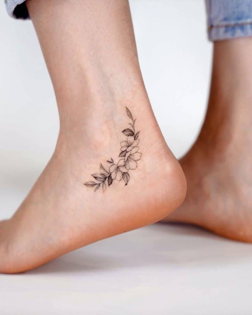 Small Black & White Flower Ankle Tattoo 