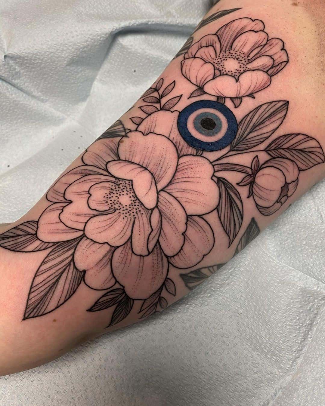 Floral & Feminine Evil Eye Tattoo 