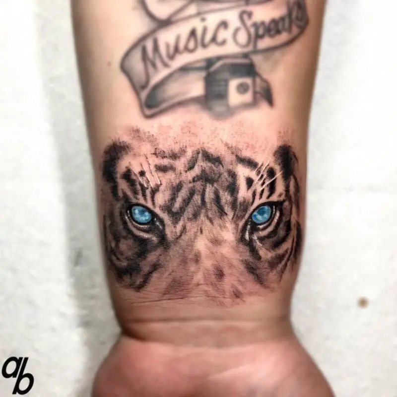 Small Wrist Tiger Eyes Tattoo Design